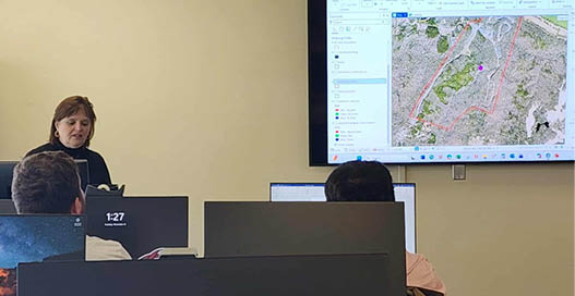 A woman is giving a presentation in a classroom setting. AI generated content